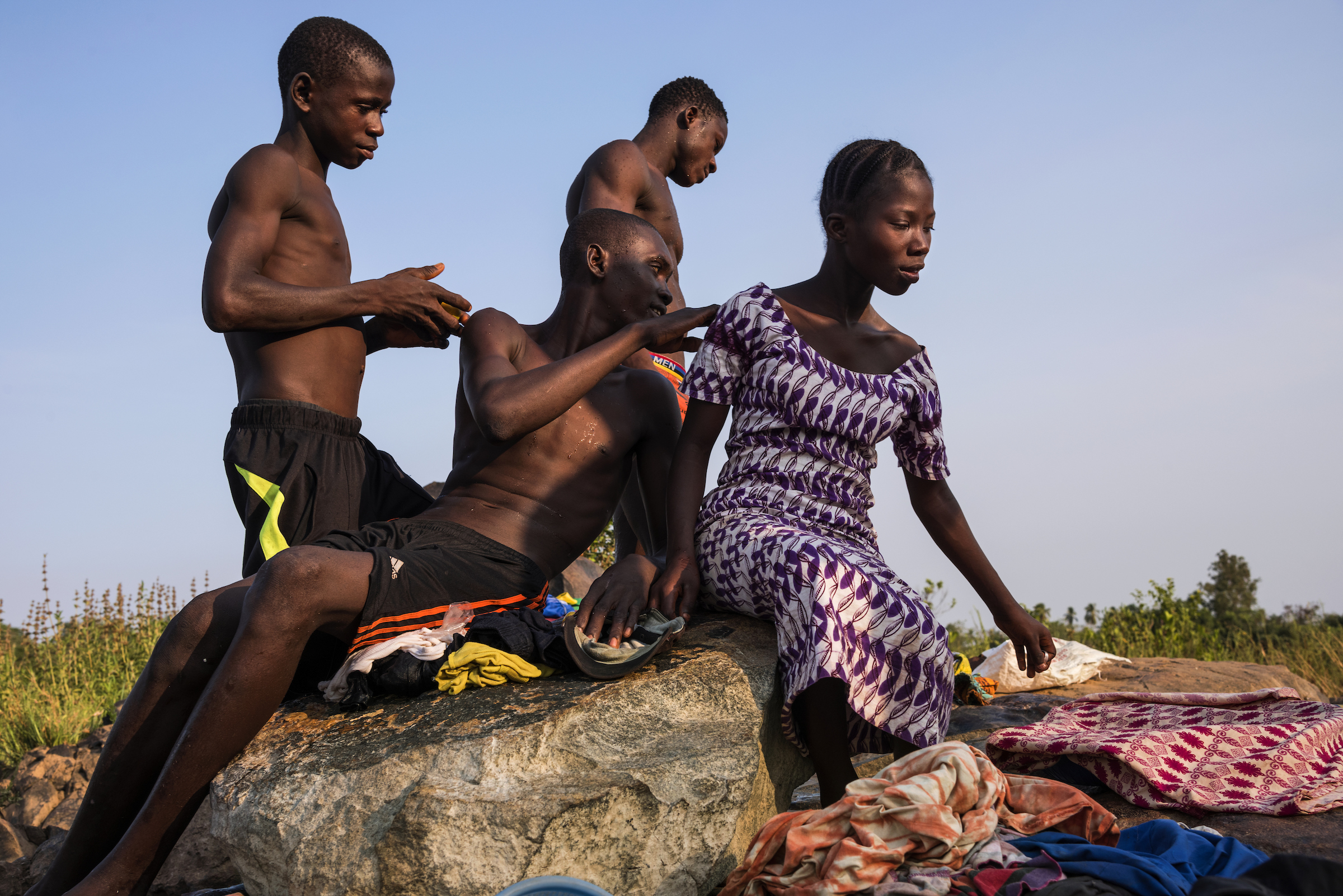 An adolescent girl takes a break from selling trinkets in Mange Bureh, Sierra Leone.