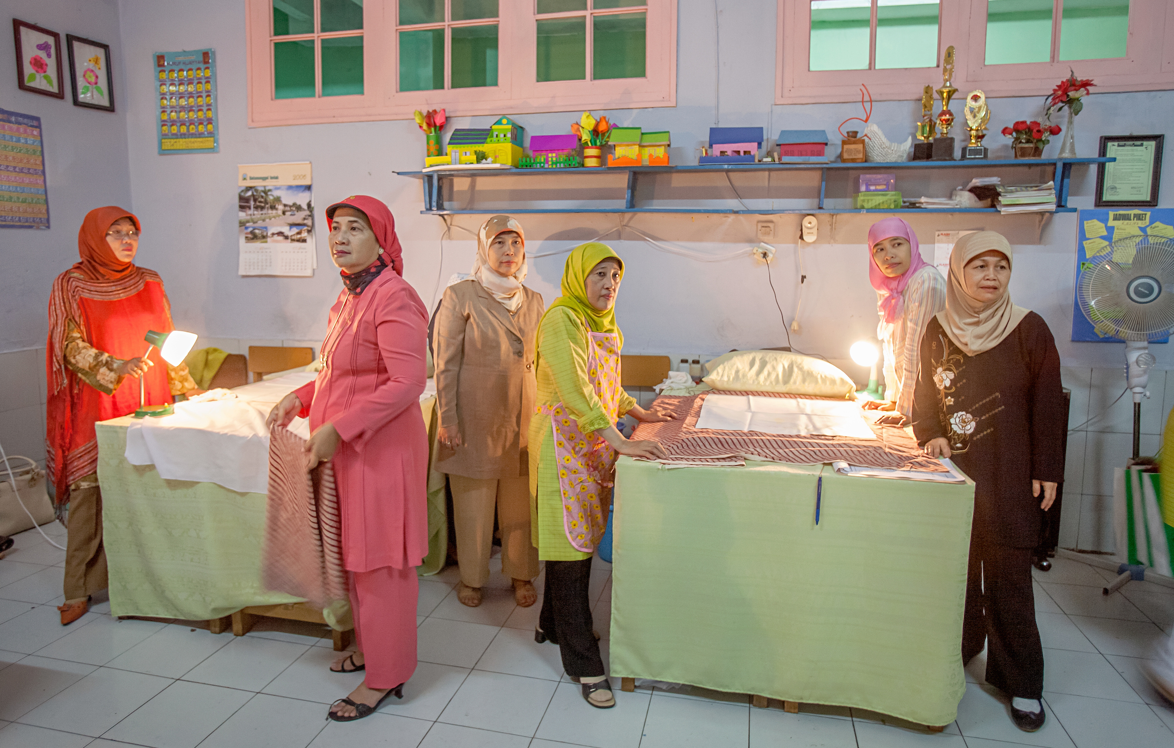 Female circumcisers and their attendants waiting for their next patients in Bandung, Indonesia.