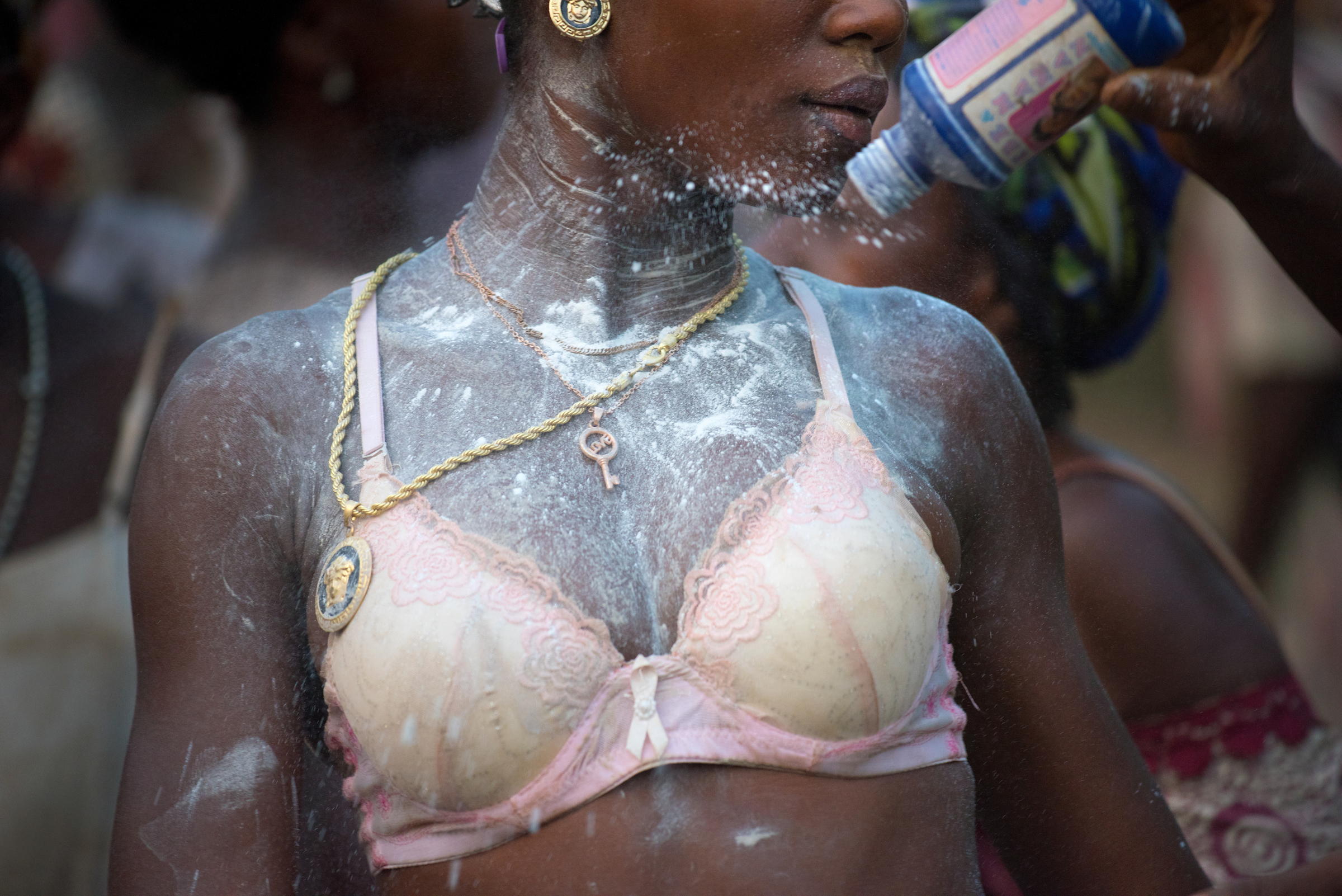 Elizabeth, 19 and Rebecca, 13, are showered in baby powder and dance in preparation for their initiation ceremony. 