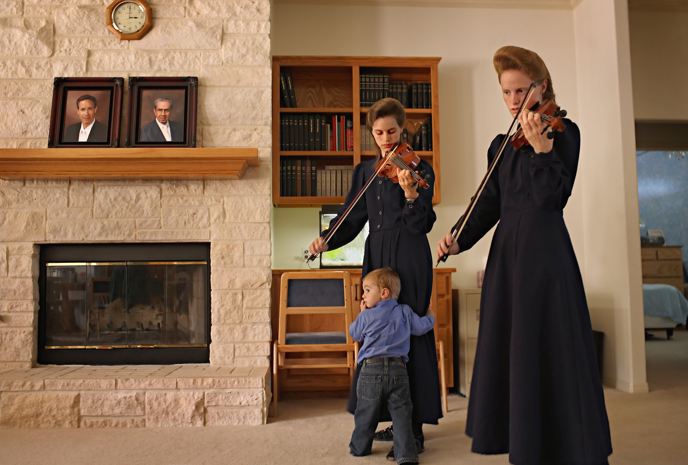 Before dinner daughters of the convicted FLDS leader play violin in the house where they took refuge after the 2008 raid.