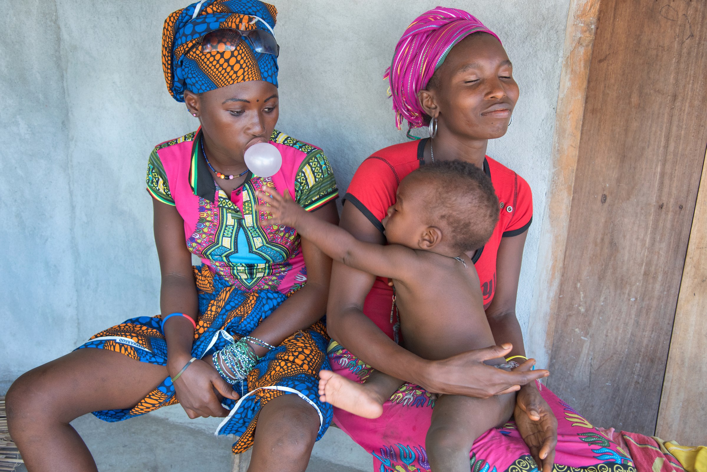 Fatmata, 15, sits with her 9-month- old son, Isa, in a small village outside of Kambia, Sierra Leone.
