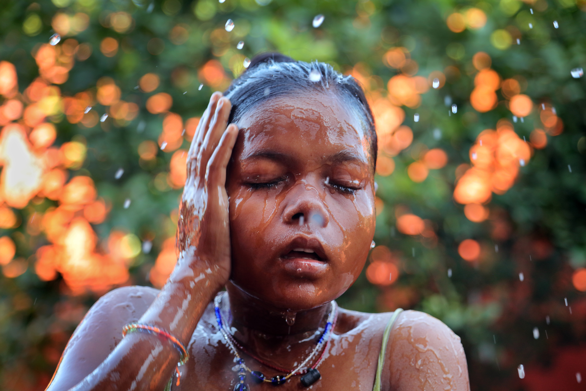 A young girl bathes before classes begin at the Kasturba Gandhi Balika Vidyalaya in Forbesganj, India.